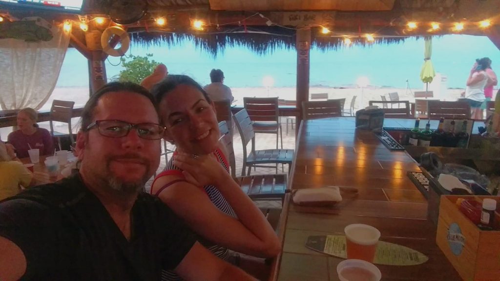Couple in beach bar with ocean in the background